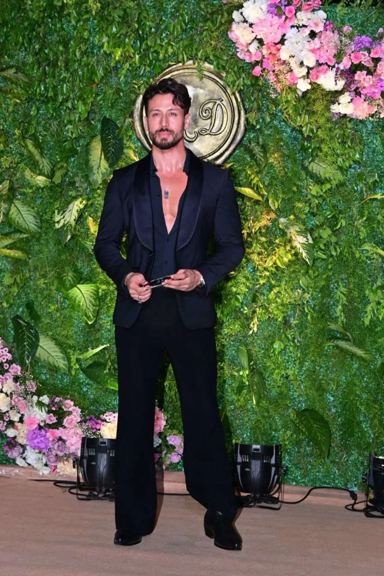 Tiger Shroff made a striking appearance at the pre-wedding celebration, dressed in a sleek all-black outfit. The actor wore a tailored black suit with a deep-neck shirt.